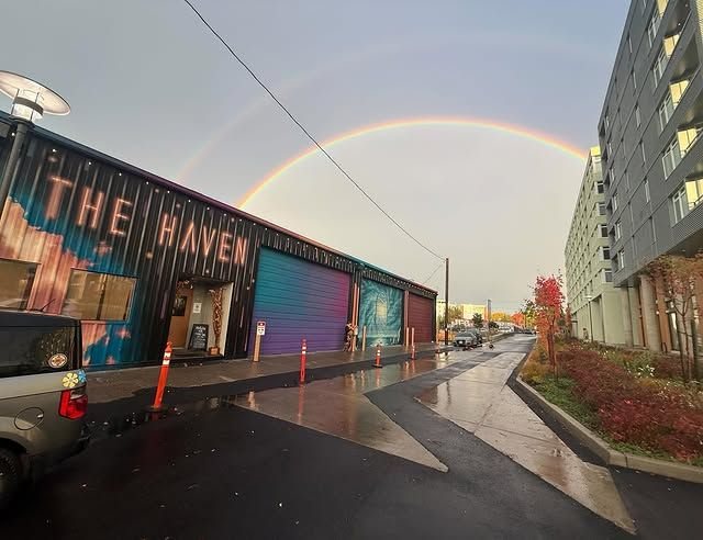 The Haven’s painted building exterior beneath a double rainbow